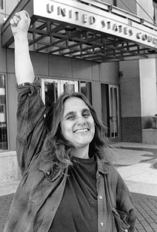 Judi Bari , always defiant, raises her fist in front of the Oakland Federal Building, 1995